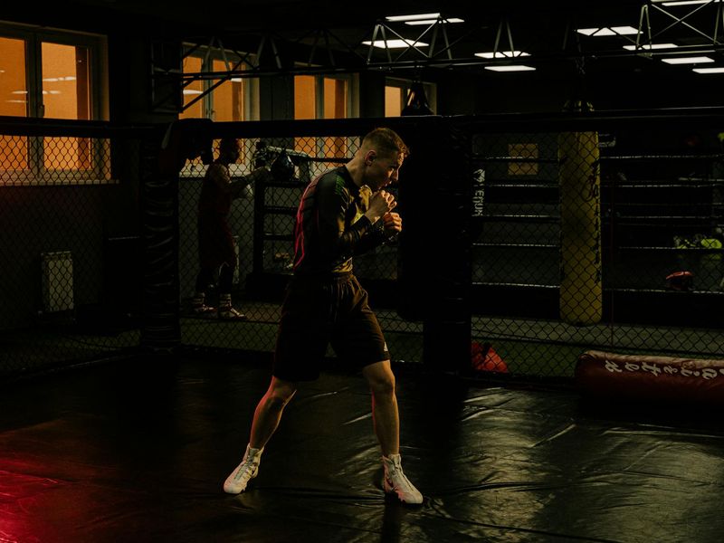 Athlete focusing before a workout session in a dark environment