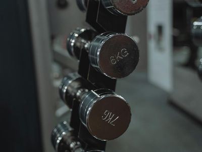 Dumbbells organized on a rack in a dark modern studio