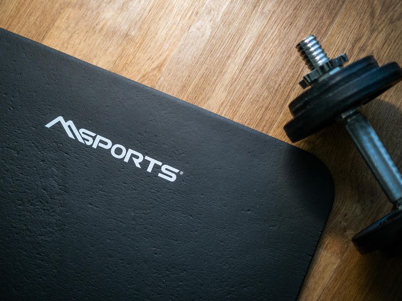 Minimalist home gym setup with weights and exercise mat